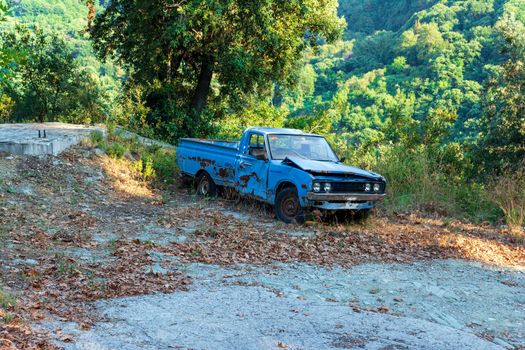 Pelion, Greece - August 13 2020: Old crashed car in the forest, Greece