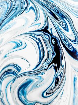 Background of an abstract blue-and-white drawing. Multi-layer pattern of mixed paint. Curved lines close up.
