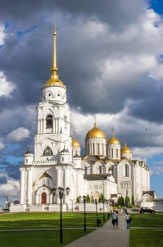 Vladimir, Russia - August 04, 2016: Assumption Cathedral. White orthodox temple with golden domes in the setting sun on the background beautiful sky. 