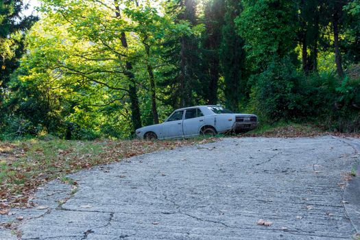 Pelion, Greece - August 13 2020: Old crashed car in the forest, Greece