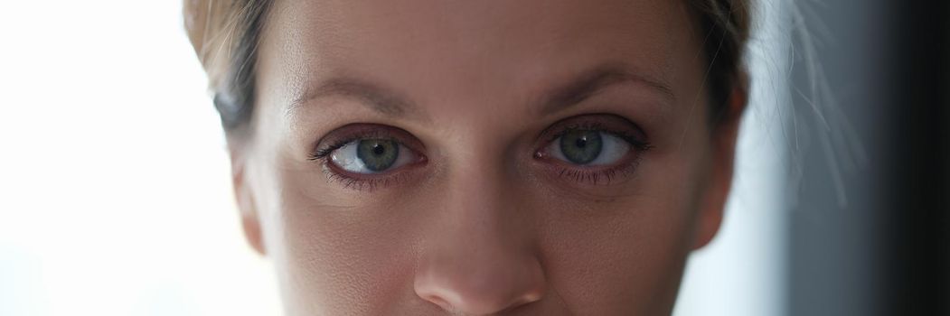 Portrait of young beautiful woman with squint eyes. Diagnosis and treatment of strabismus in adults concept