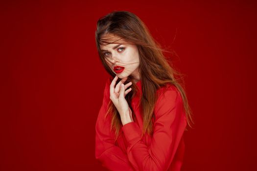 woman with red hair fashion posing red shirt glamor. High quality photo