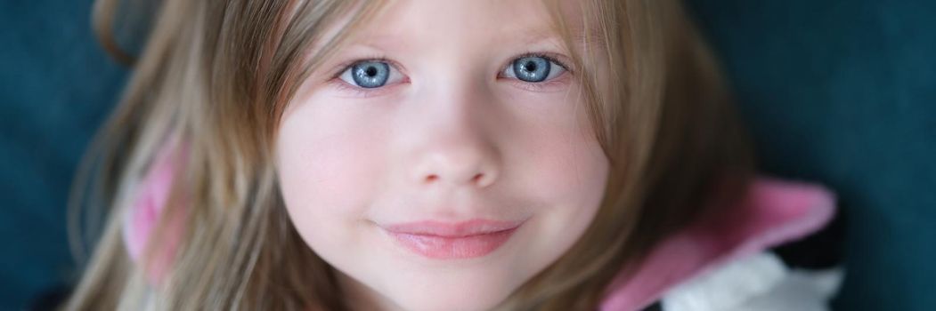 Portrait of beautiful cute little girl with blue eyes. Child caucasian appearance concept