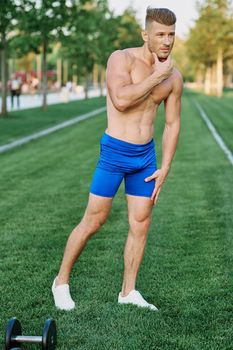 Muscled Man Doing Exercises Outdoor Fitness Summer. High quality photo