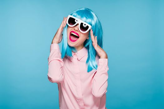 attractive woman in purple wig sunglasses model blue background. High quality photo