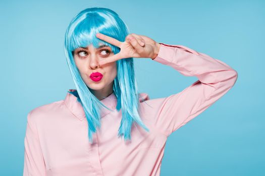 cheerful glamorous woman in pink shirt blue wig makeup model. High quality photo