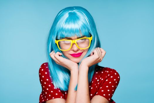 glamorous woman in blue wig yellow glasses posing model. High quality photo