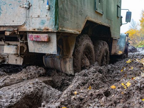 The truck got stuck on a dirty, broken forest road. Autumn thaw. Off road.