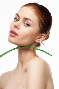 woman with bare shoulders aloe cosmetics spa treatments. High quality photo