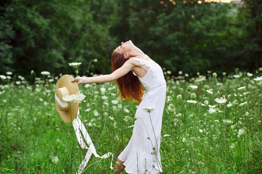 cheerful woman in a field outdoors flowers fresh air freedom. High quality photo