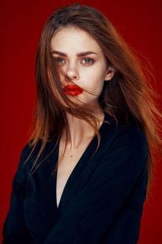 pretty woman with red lips red hair Glamor posing red background. High quality photo