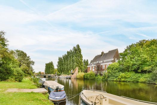A large canal surrounded on both sides by a lawn path