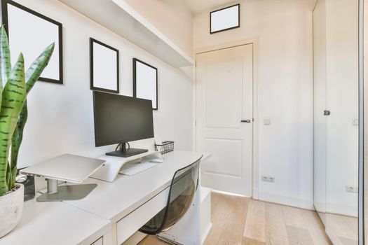 Luxurious study with a computer and paintings on the wall