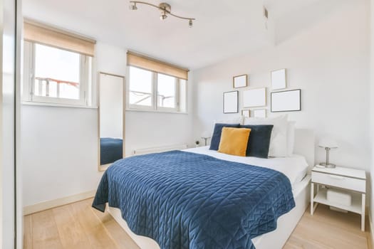 Luxurious bedroom with soft bed and blue bedspread