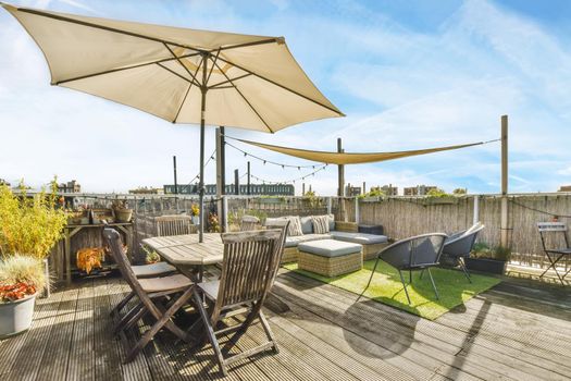 Luxurious and stylish courtyard with a garden umbrella and lots of furniture