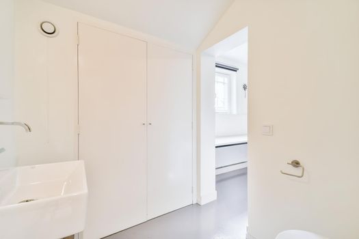 A room with an open door and a sink in an elegant home