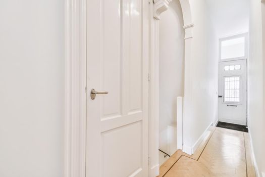 Two white doors in a bright corridor