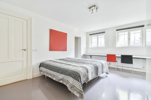 Luxurious bedroom with soft bed and fluffy bedspread