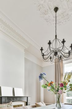 Graceful ceiling with a pattern and a chandelier in the middle