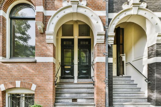 Front door to a brick house with a staircase