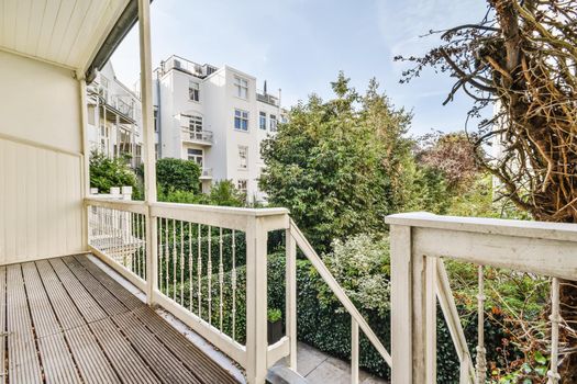 Attractive long narrow balcony with wooden handrails