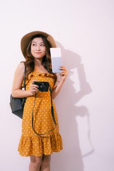 Beautiful travel woman with passport isolated on pastel backgroun