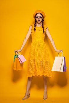 pretty woman shopping entertainment lifestyle yellow background. High quality photo