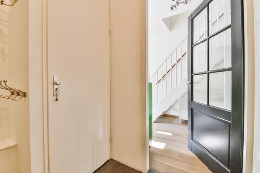 Interior of contemporary flat in minimal style with spacious hallway with white walls