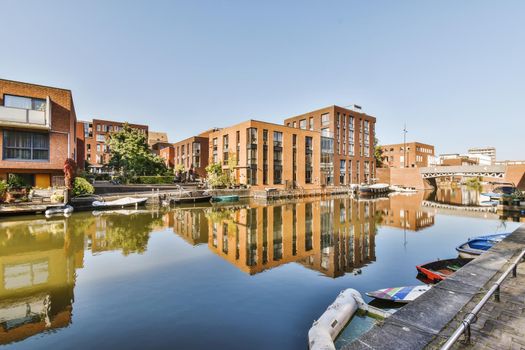 Brick buildings next to a lake with parked boats
