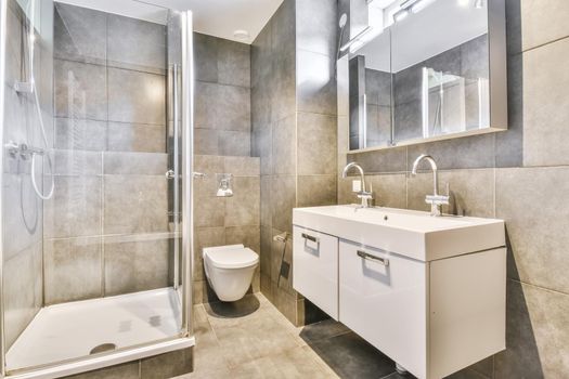 Modern home interior design of white bathroom with open shower separated from toilet