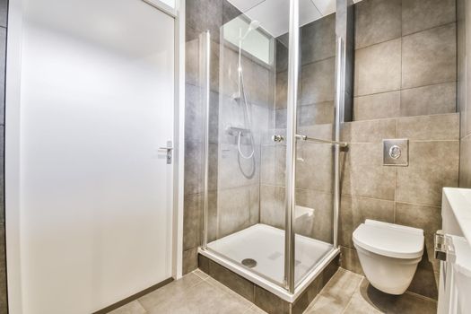 Modern home interior design of white bathroom with open shower separated from toilet