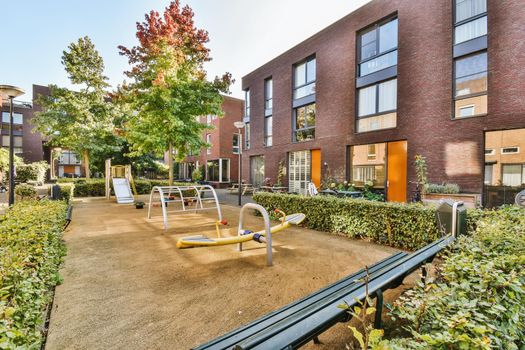 The courtyard of the house with a playground with a swing
