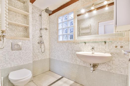 Interior of contemporary bathroom with shower and sink in minimal style in flat