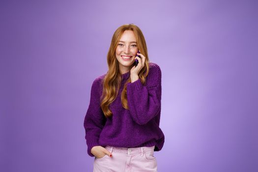 Girl likes talking on mobile phone with funny friend. Portrait of carefree charming redhead european woman with freckles holding mobile phone near ear as having conversation, laughing joyfully. Technology and communication concept