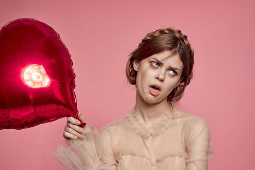 cheerful woman in a dress balloon Valentine's Day model studio. High quality photo