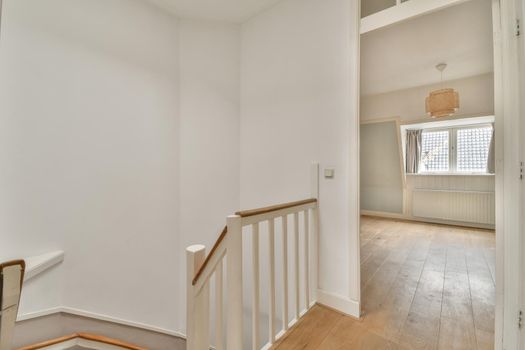 Modern room with wooden floor and white walls