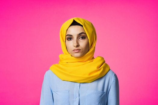 muslim woman in hijab posing fashion ethnicity pink background. High quality photo