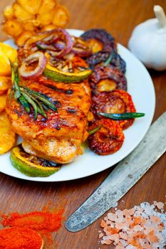 roasted grilled BBQ chicken breast with herbs and spices rustic style