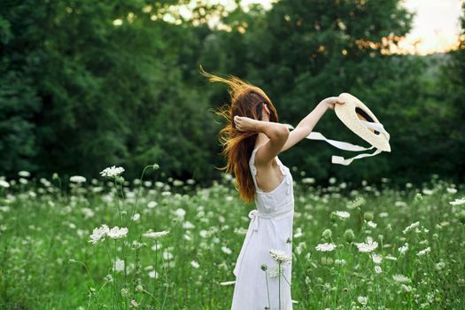 pretty woman in a field in nature white dress fresh air. High quality photo