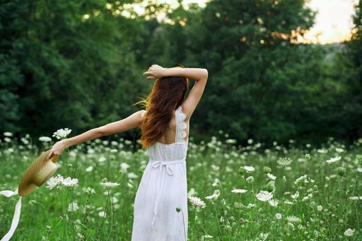 pretty woman in a field in nature white dress fresh air. High quality photo