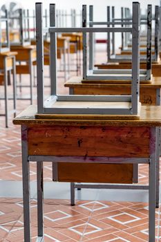 Desk and chairs in classroom at school