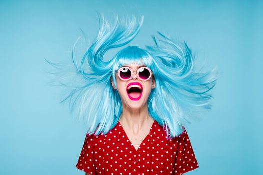 emotional glamorous woman on blue wig fashion glasses posing. High quality photo