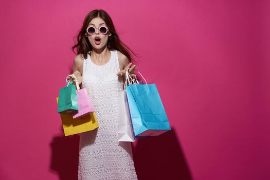 fashionable woman with multicolored bags posing isolated background. High quality photo