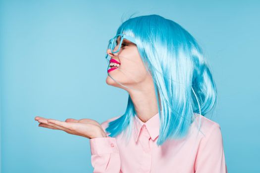 pretty woman in pink shirt purple wig glasses red lips. High quality photo