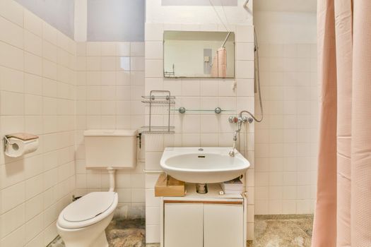 Very cozy bathroom with a pink curtain separating the shower