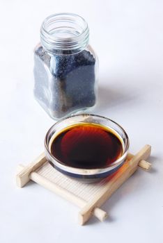 Black Cumin oil in a container on table..