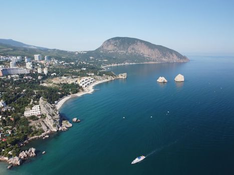 GURZUF, CRIMEA - Aerial View on the famous rocks Adalary, Two Twin-Cliffs with an edge of mountain Au-Dag in early spring morning at the South coast of Crimean Peninsula. Copy space