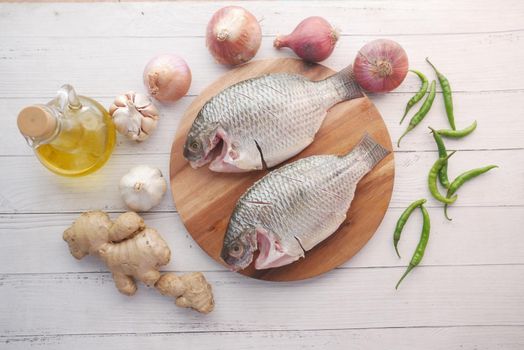 raw fresh sea fish on plate on table