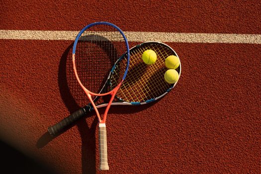 Tennis Ball with Racket on the racket in tennis court.