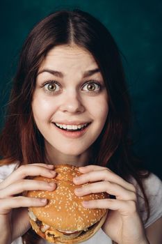 cheerful woman eating hamburger snack close-up lifestyle. High quality photo